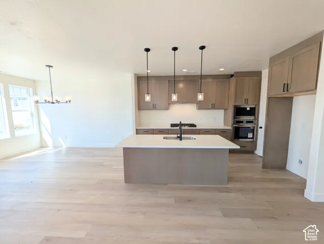 Spacious open-concept layout with light wood-finish flooring