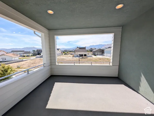 Covered exterior patio featuring a concrete floor and integrated recessed lighting