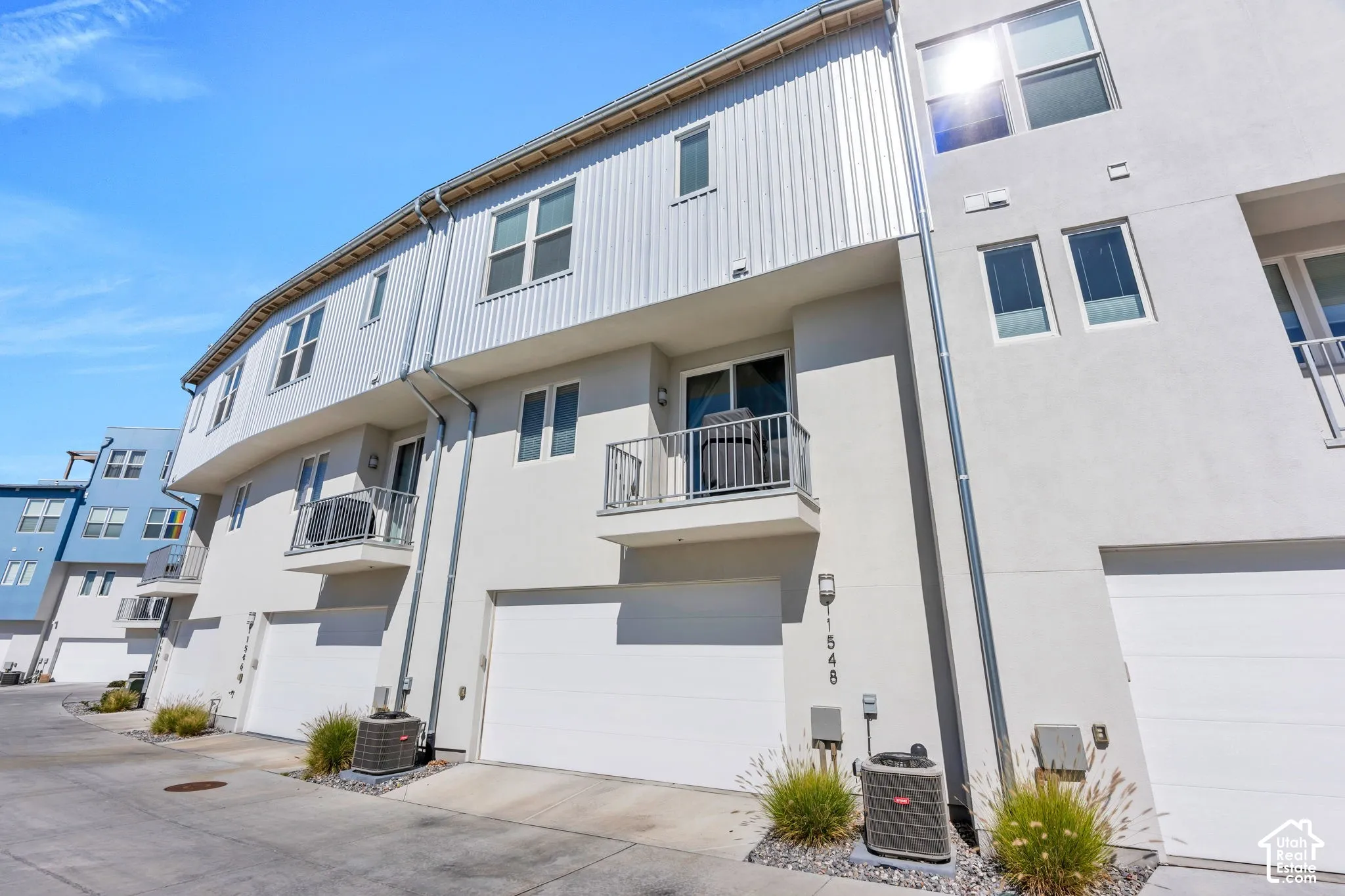 Contemporary multi-level exterior with stucco and corrugated metal siding