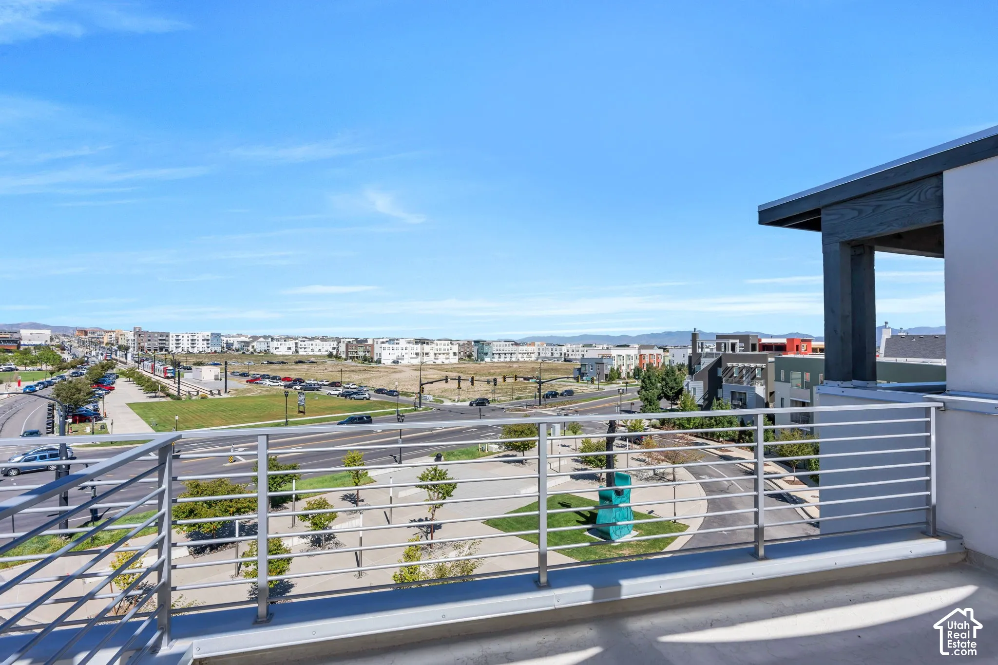 Balcony with horizontal bar railing and concrete flooring