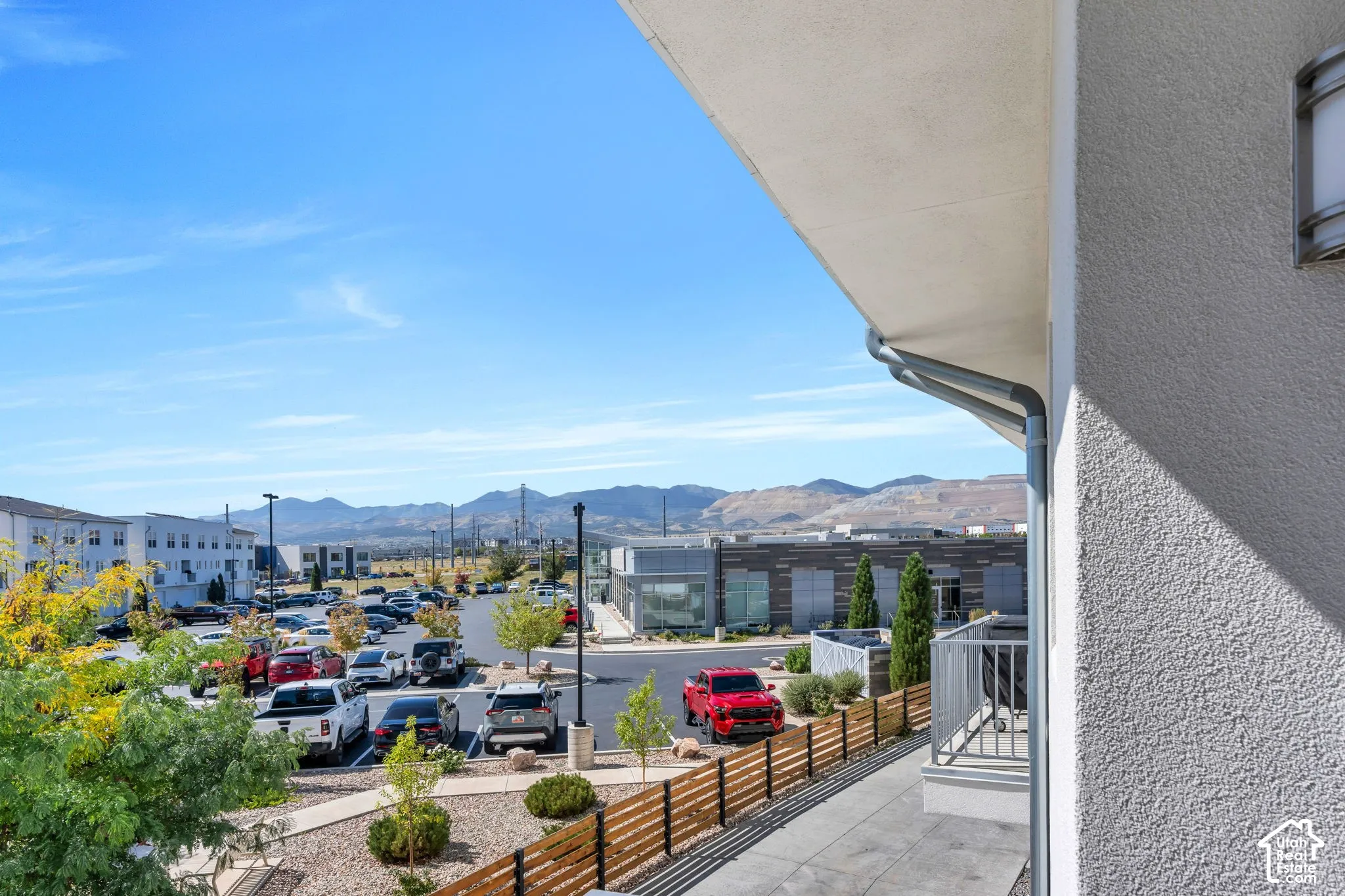 Stucco exterior with an attached gutter system and outdoor lighting