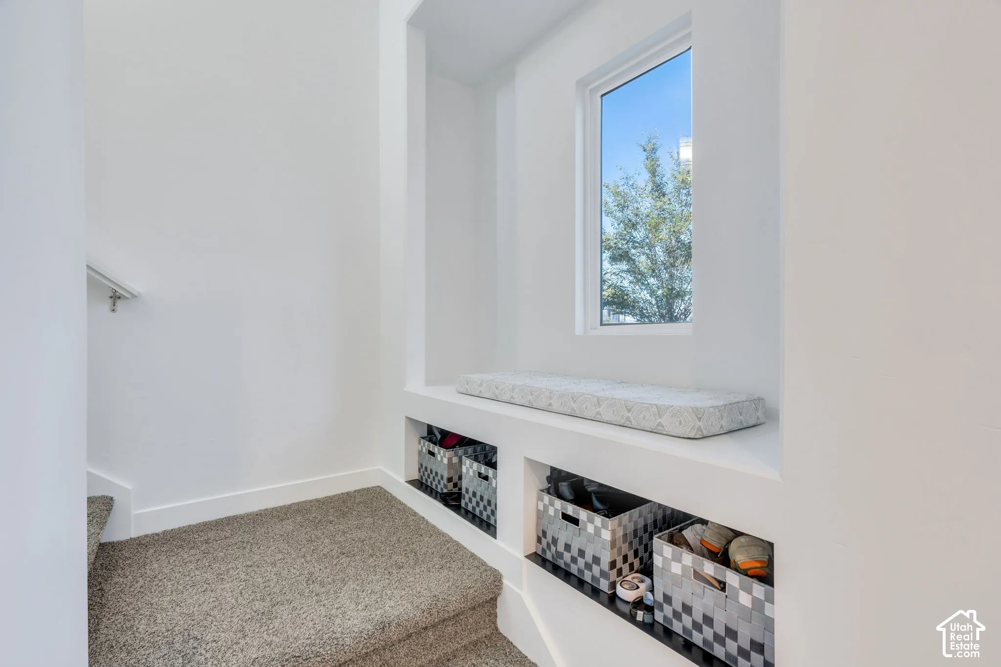 Built-in storage bench with an integrated window, offering natural illumination