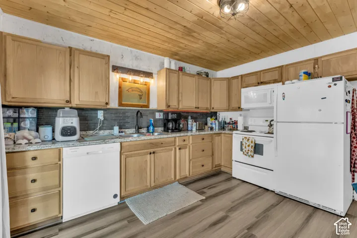 Wood-finish flooring, wood plank ceiling, light wood cabinetry, stone-finish countertops, and a tile backsplash