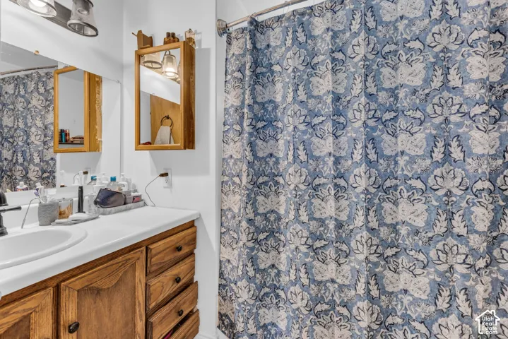 Wood-finish vanity with a white countertop and integrated sink