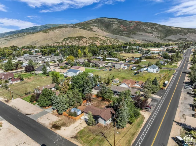 Neighborhood setting with mountain backdrop and mature trees