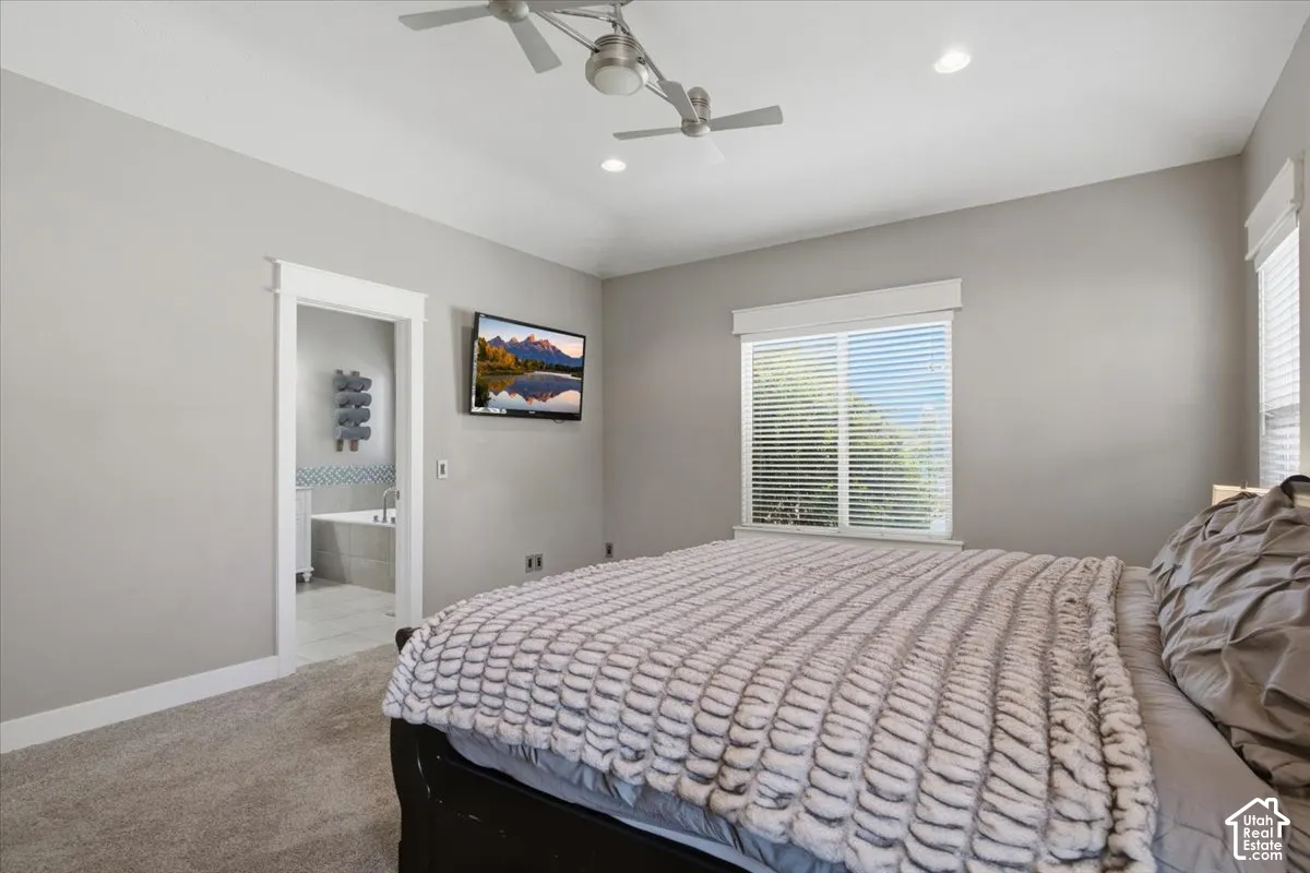 Vaulted ceiling with dual ceiling fans, recessed lighting, carpet flooring, and window with blinds