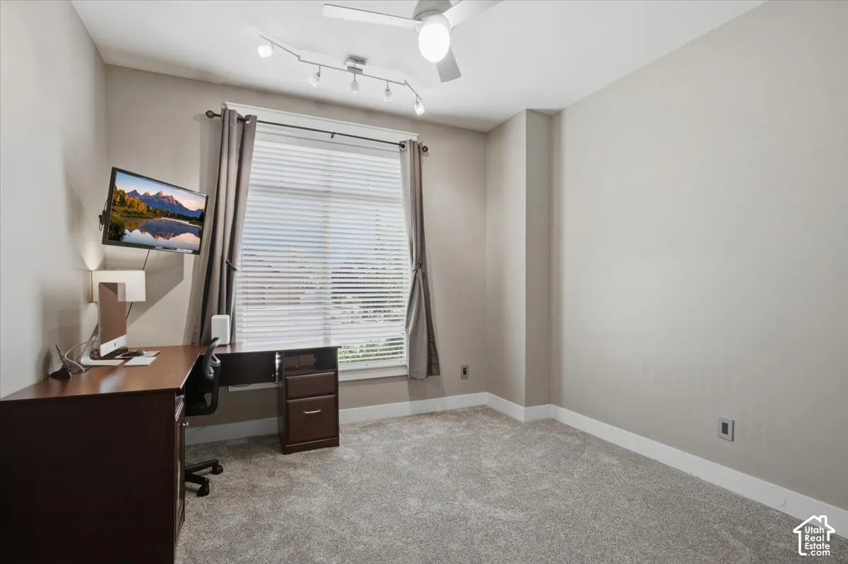 Neutral-toned walls complement the gray carpeting