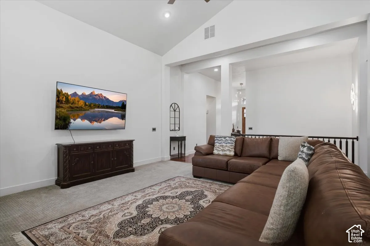 Vaulted ceiling, recessed lighting, and white walls