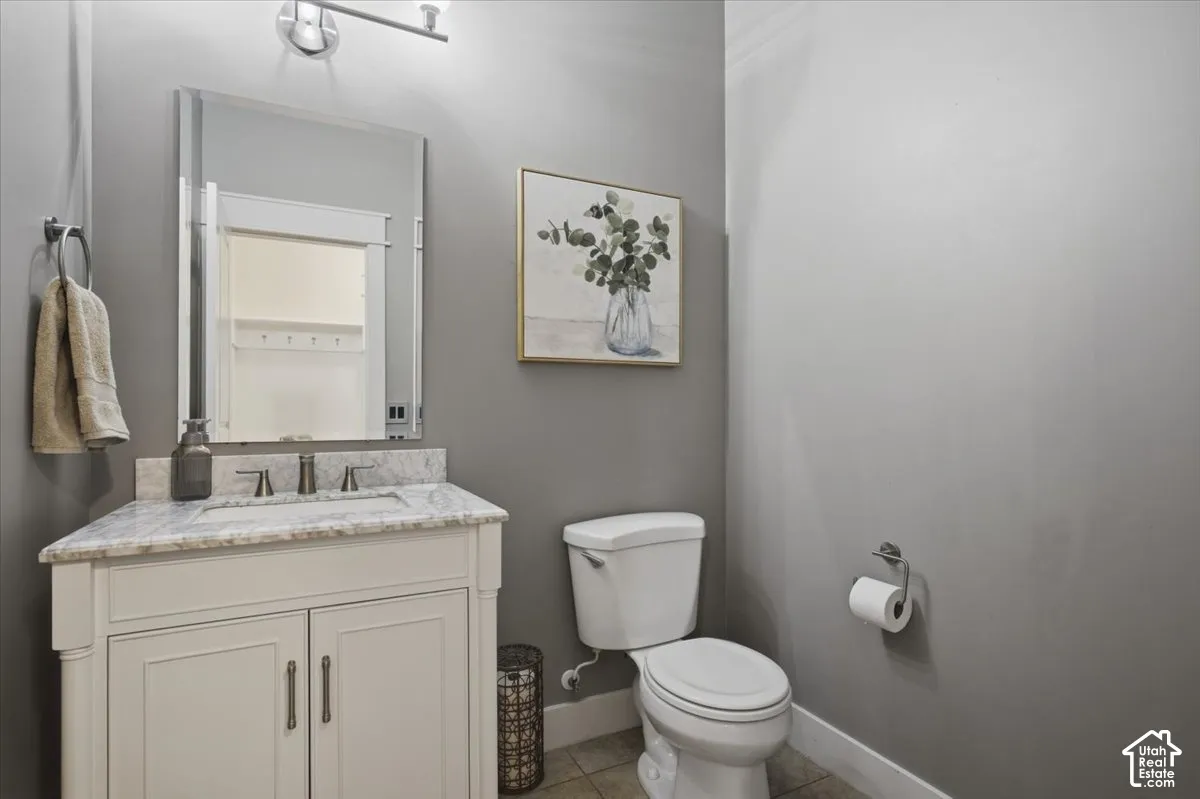 Vanity with a light-toned countertop, integrated sink, and dual-handle faucet
