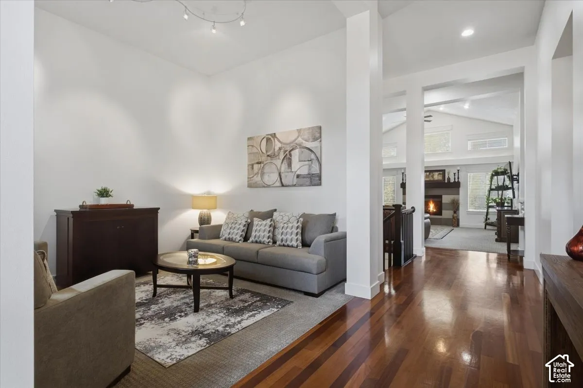Hardwood flooring throughout, vaulted ceilings, recessed lighting, and a prominent fireplace