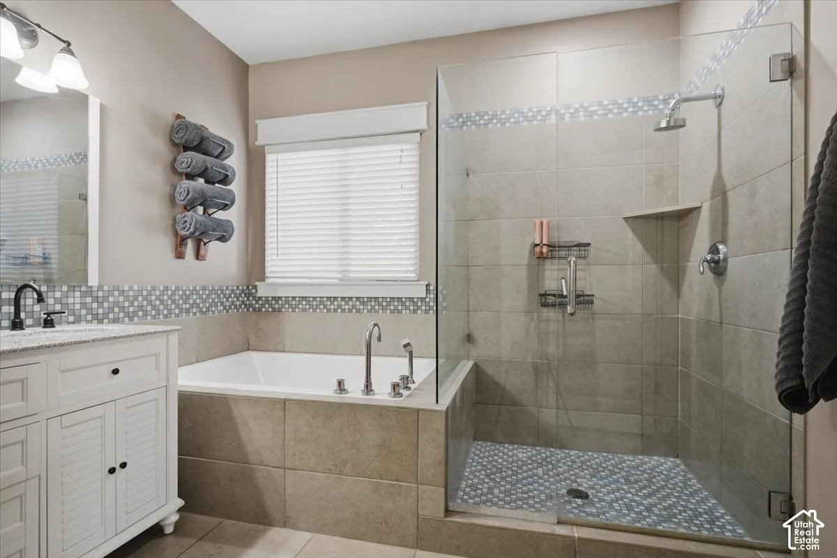 Glass-enclosed shower with a tiled floor and built-in shelf