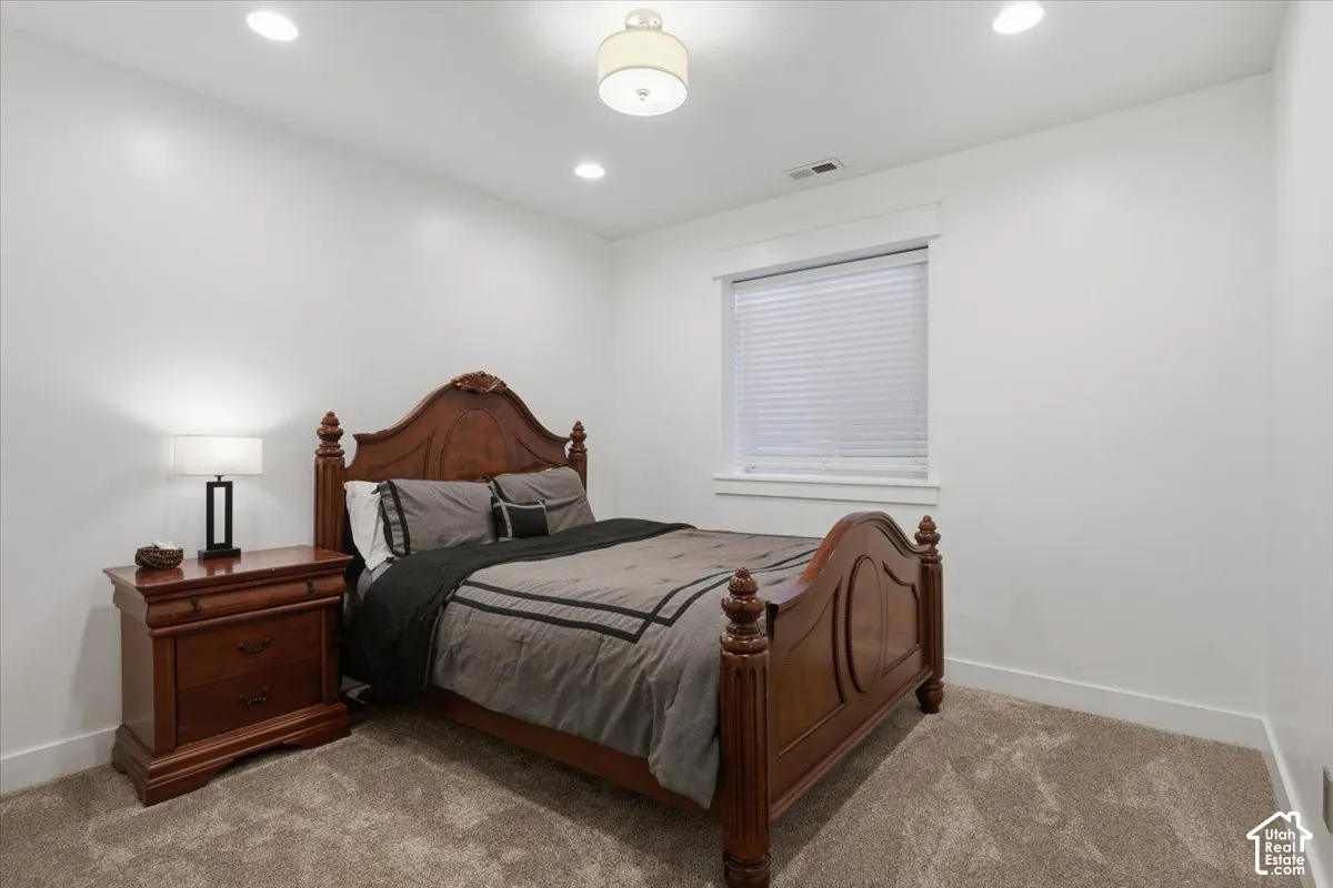 Recessed lighting and a central flush-mount fixture illuminate the space
