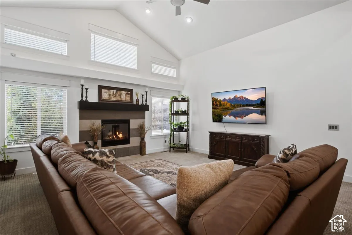Vaulted ceiling with recessed lighting and a ceiling fan