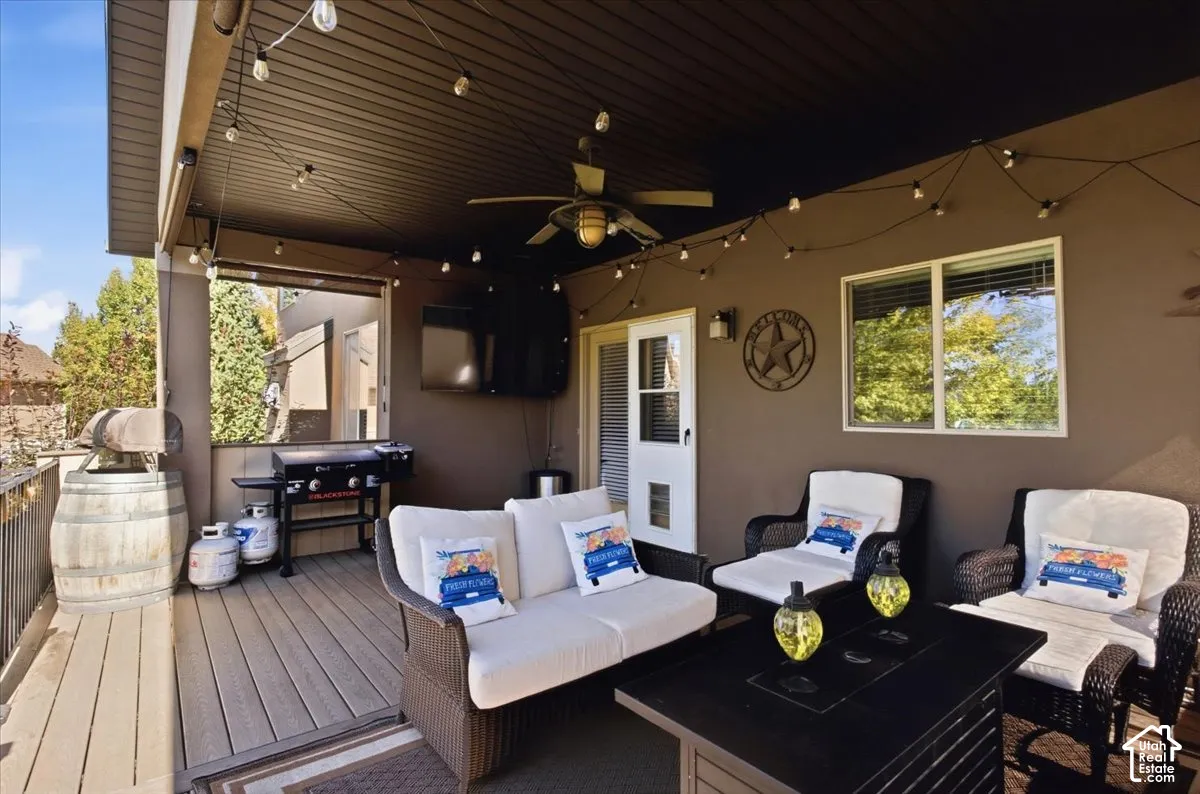 Covered patio featuring a ceiling fan, recessed lighting, and a white framed window