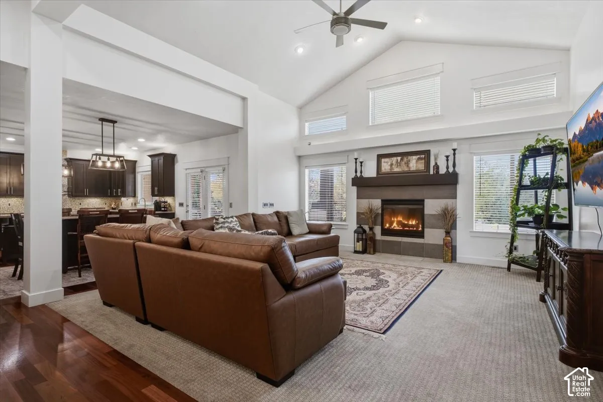 Vaulted ceiling with recessed lighting and a ceiling fan