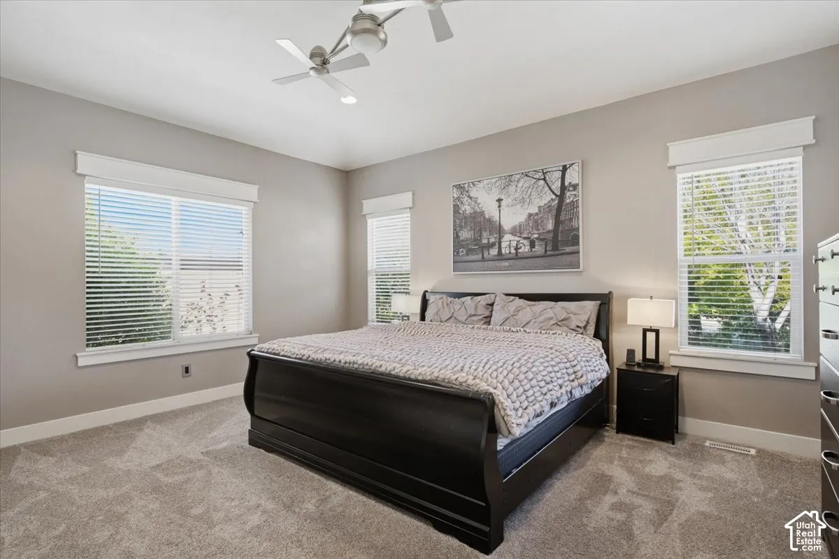 Soft neutral wall tones, white trim, and ceiling fans