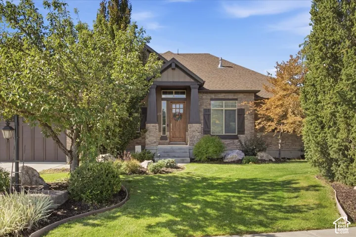 Stone and siding exterior with dark wood accents