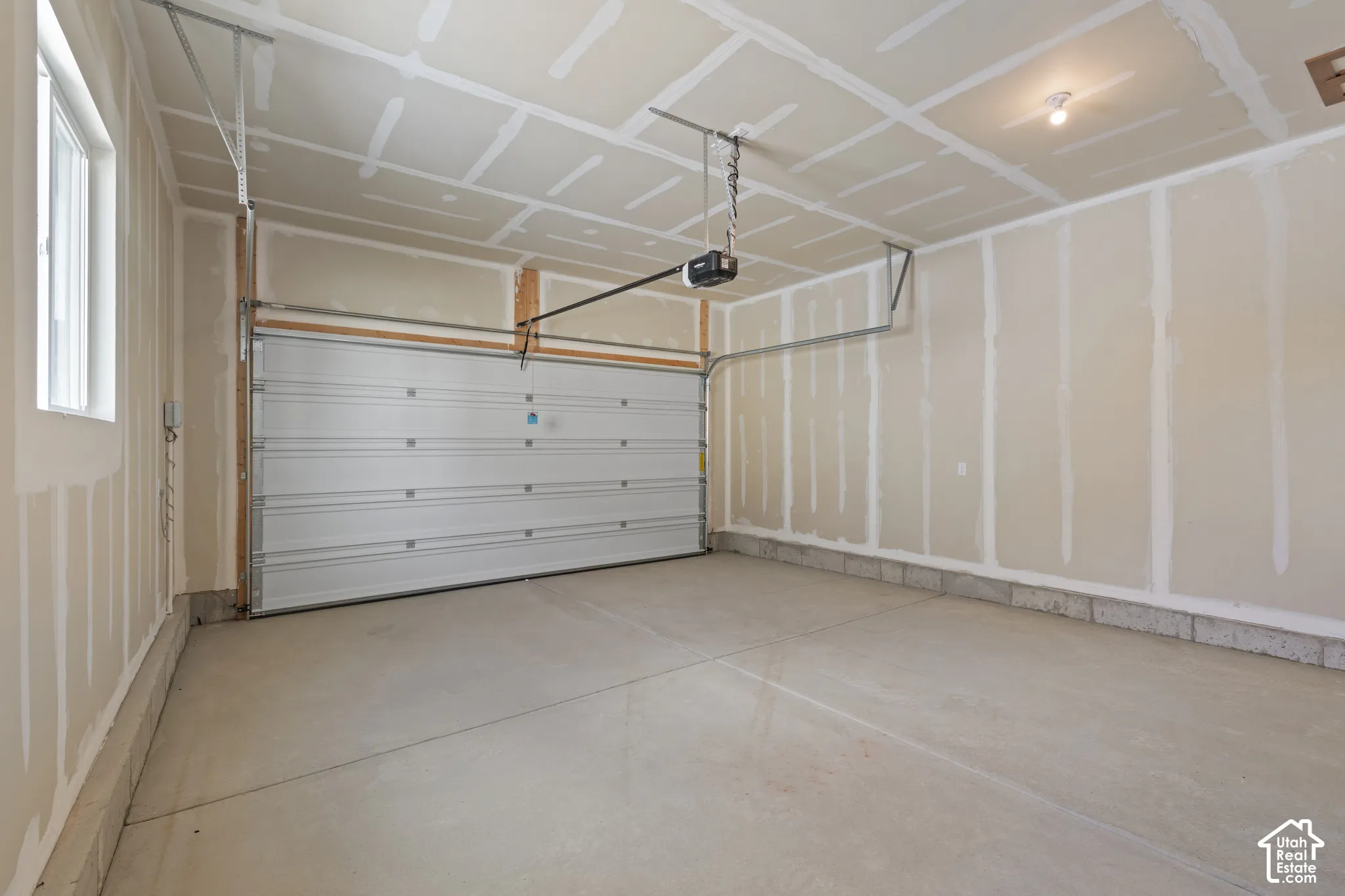 Concrete flooring, automatic garage door opener, overhead lighting, window for natural light
