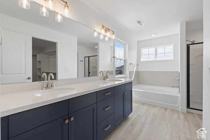 Dual vanity with crisp white countertops, deep blue cabinetry, and brushed nickel hardware