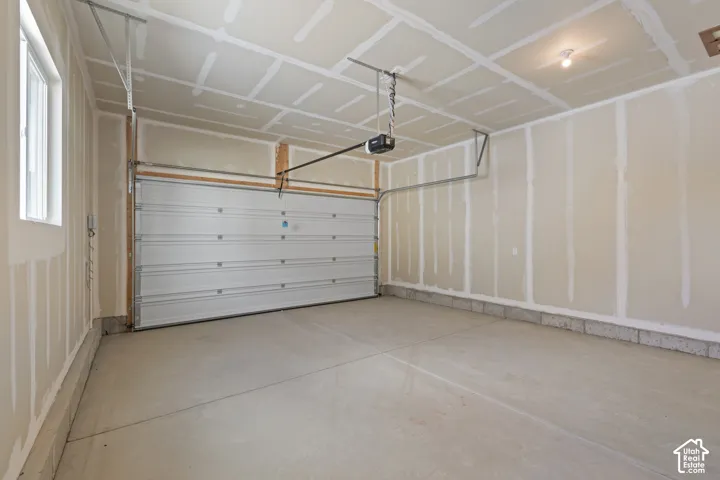 Concrete flooring, automatic garage door opener, overhead lighting, window for natural light