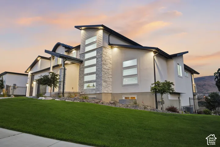 Modern architectural exterior with a stucco and stacked stone facade