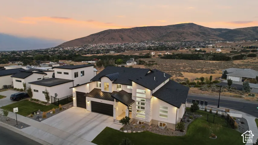 Modern architecture featuring a multi-level design, attached two-car garage, and a concrete driveway