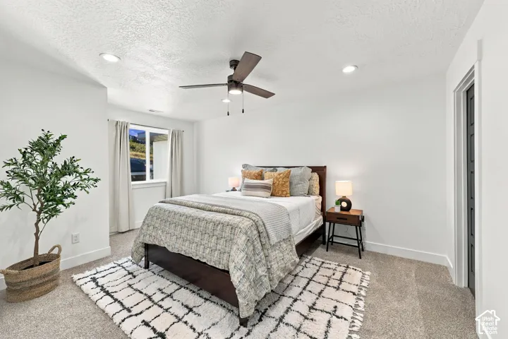Recessed lighting, ceiling fan, white walls, and a window with a mountain backdrop
