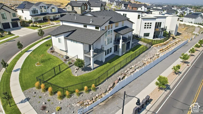 Contemporary residence with white siding and a black roof