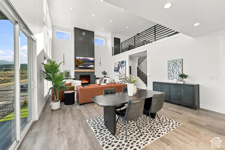 Expansive living area with high ceilings, recessed lighting, and wood-finish flooring