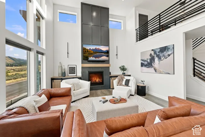 Two-story living area with a fireplace and tall windows