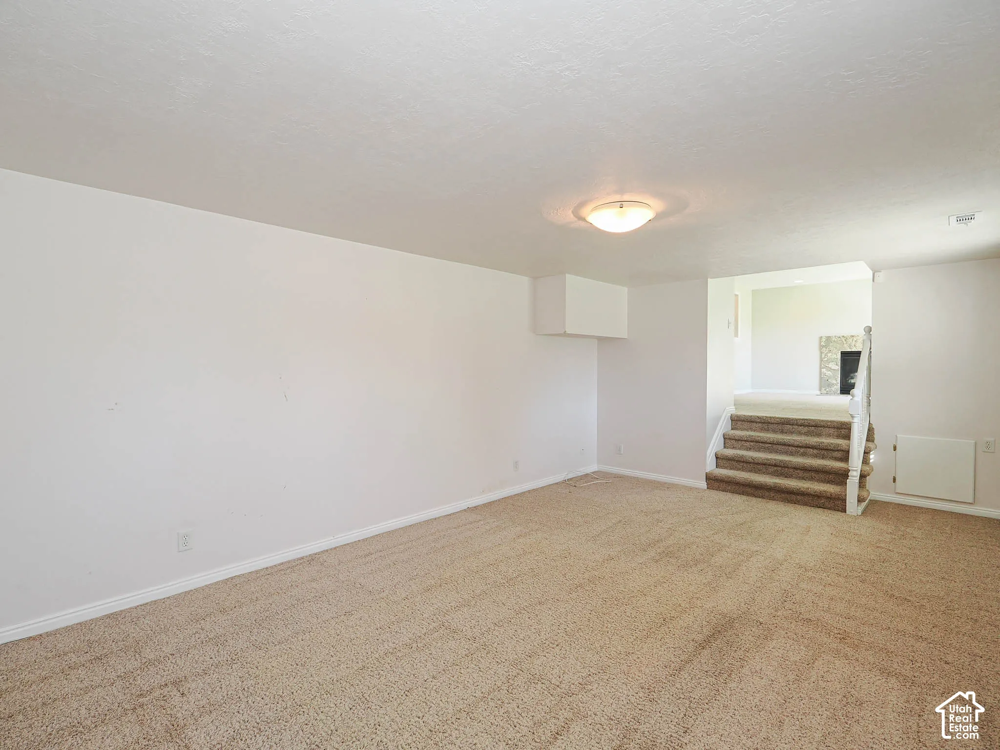Carpeted flooring, recessed lighting, and white walls
