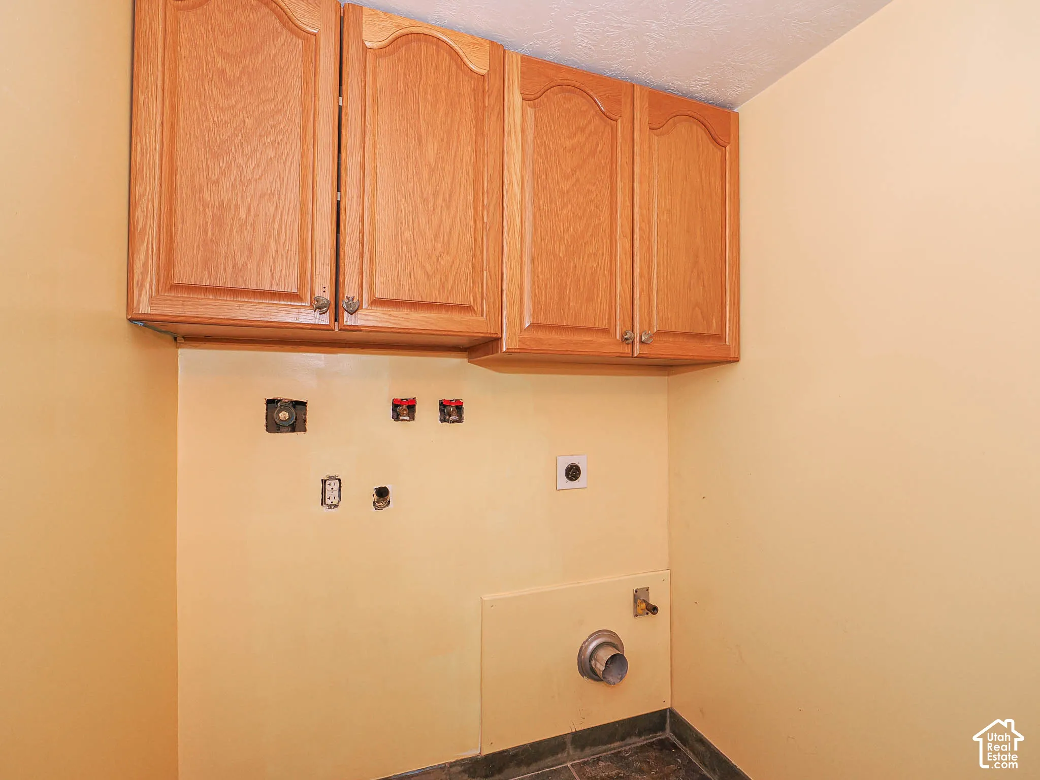 Upper cabinetry with wood-finish doors and decorative hardware