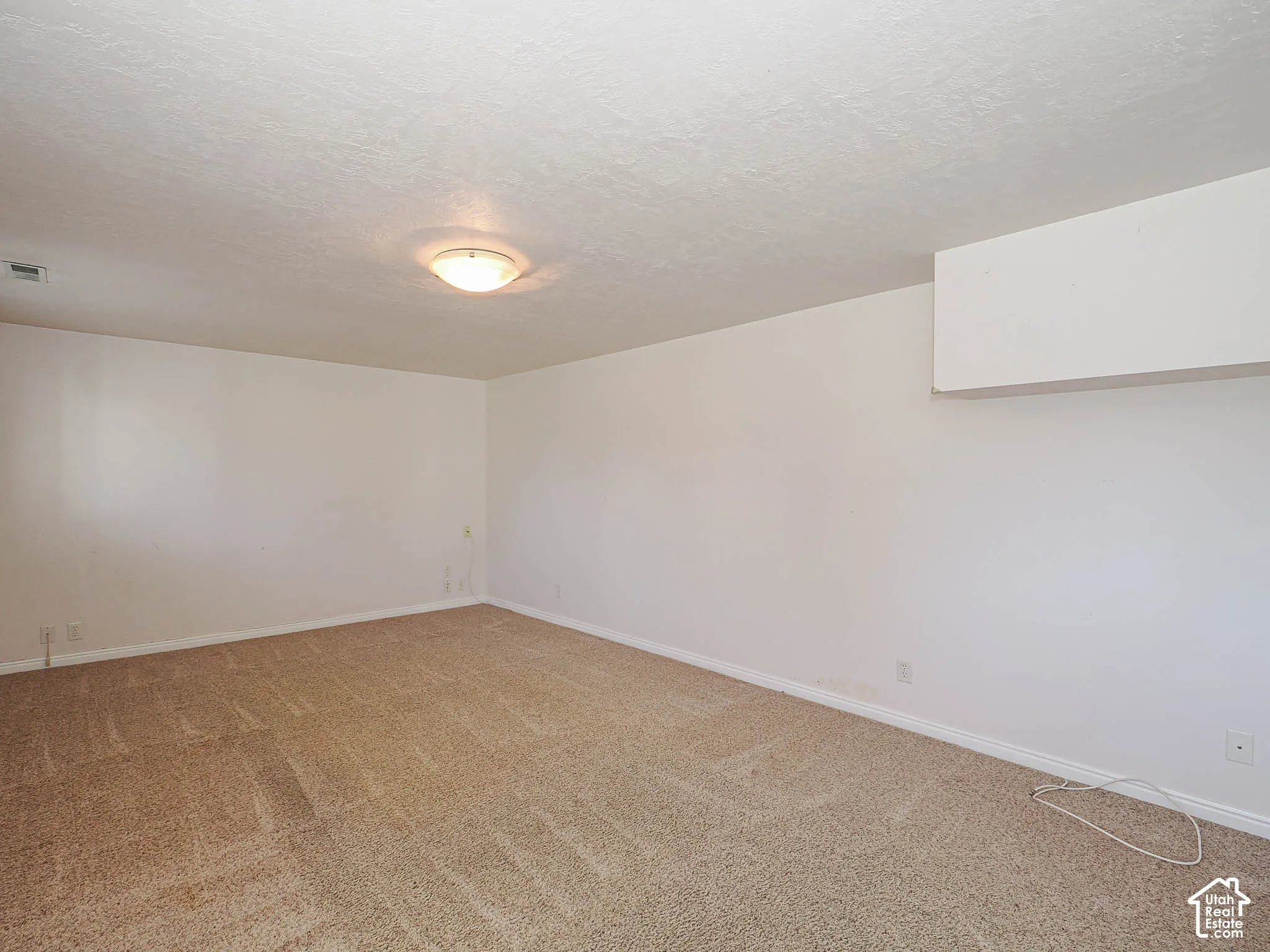 Textured ceiling with a flush-mount light fixture