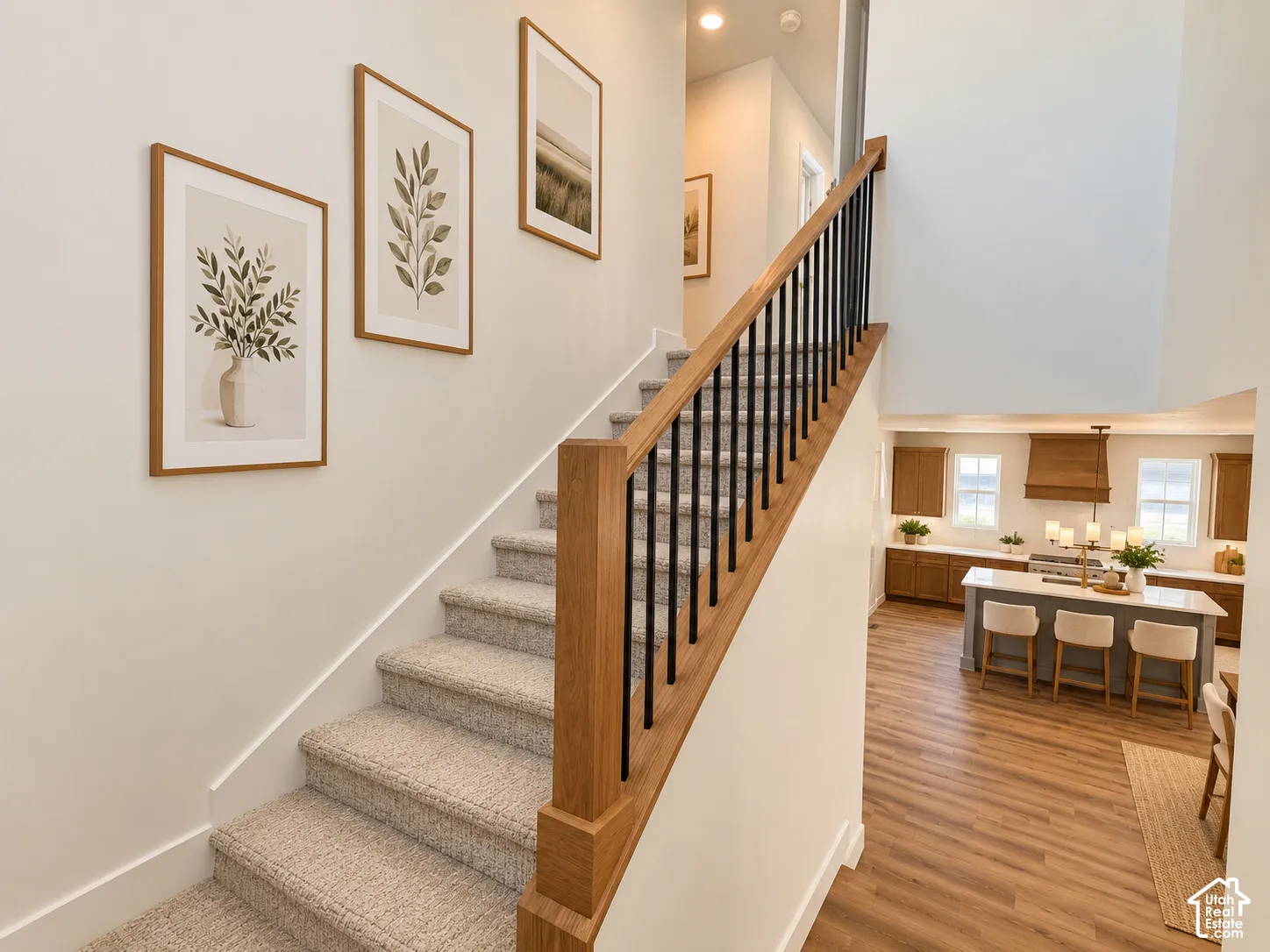 Staircase featuring wood railings and black balusters, carpeted steps, and light-toned wall finishes