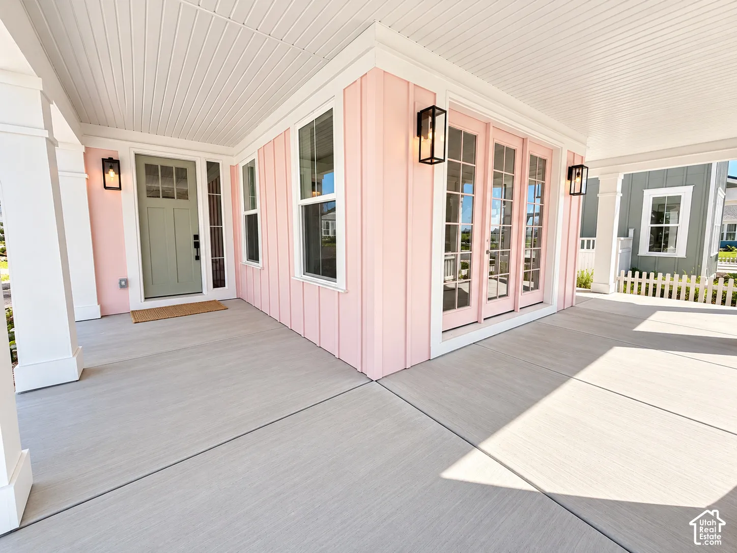 Expansive covered porch featuring a beadboard ceiling, recessed lighting, and a durable concrete surface