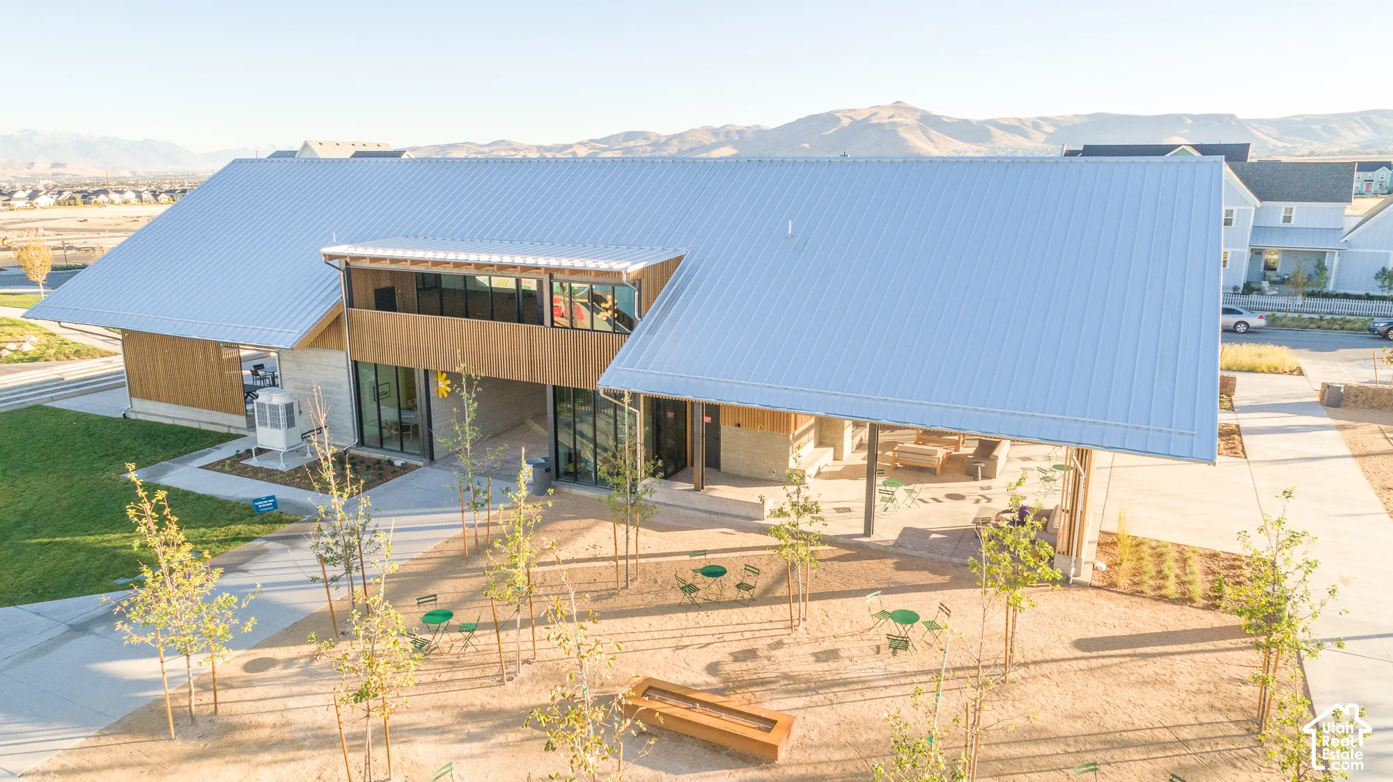 Modern building featuring a metal roof, wood siding, and large glass panels