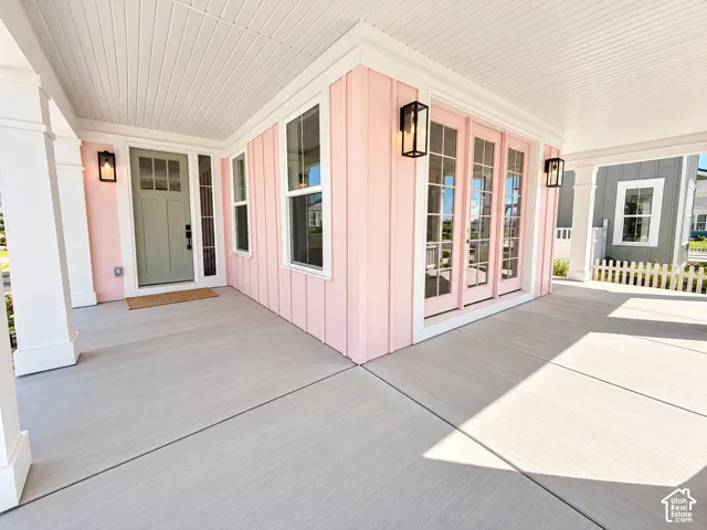 Expansive covered porch featuring a beadboard ceiling, recessed lighting, and a durable concrete surface