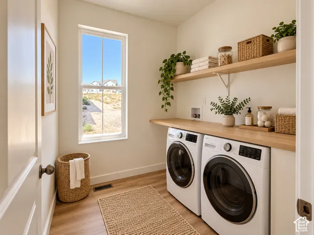 Laundry area featuring wood-finish flooring, a double window, built-in shelving, and a wood-finish countertop