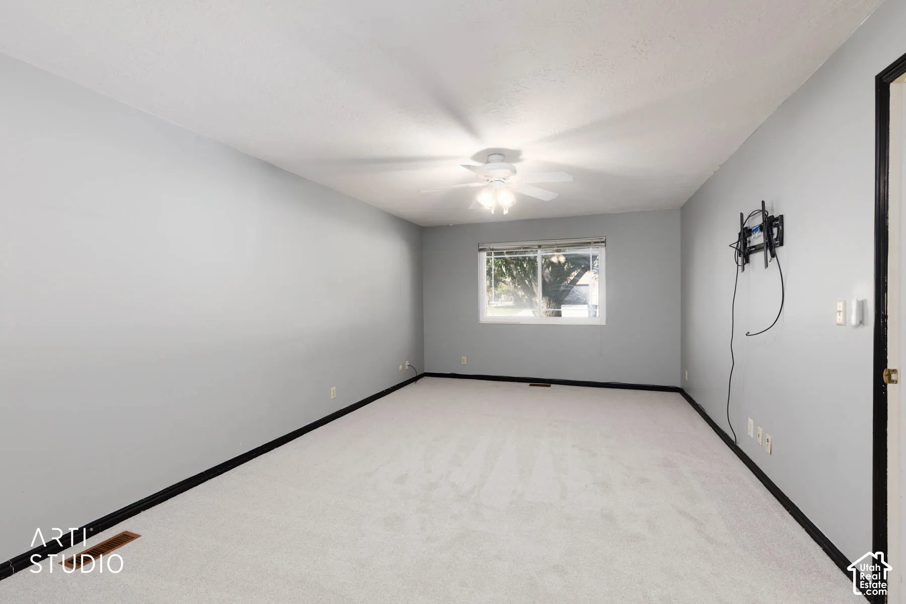 Room with light grey painted walls and light-colored carpet flooring