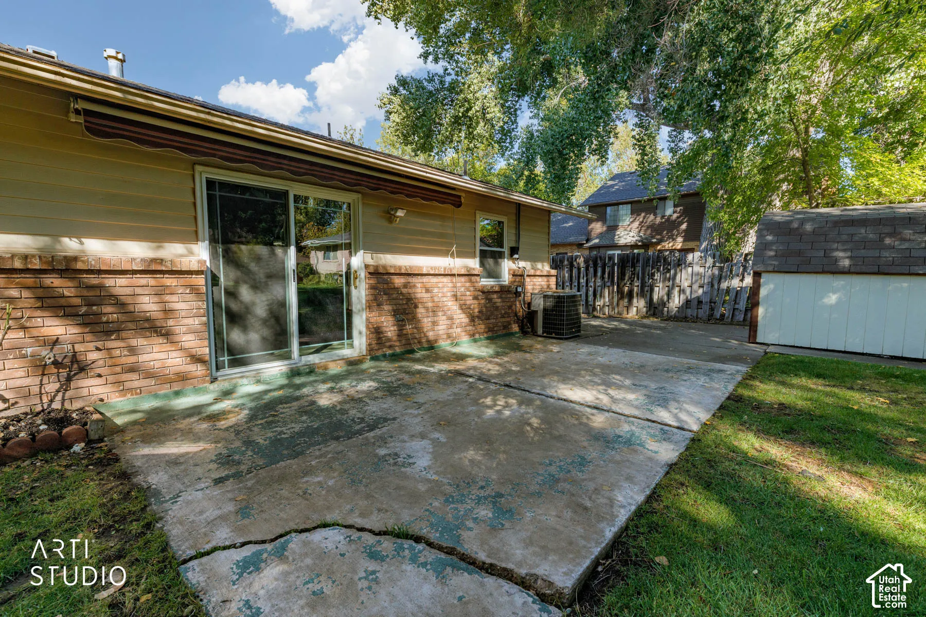 Exterior featuring brick and siding, a sliding glass door, and an attached awning