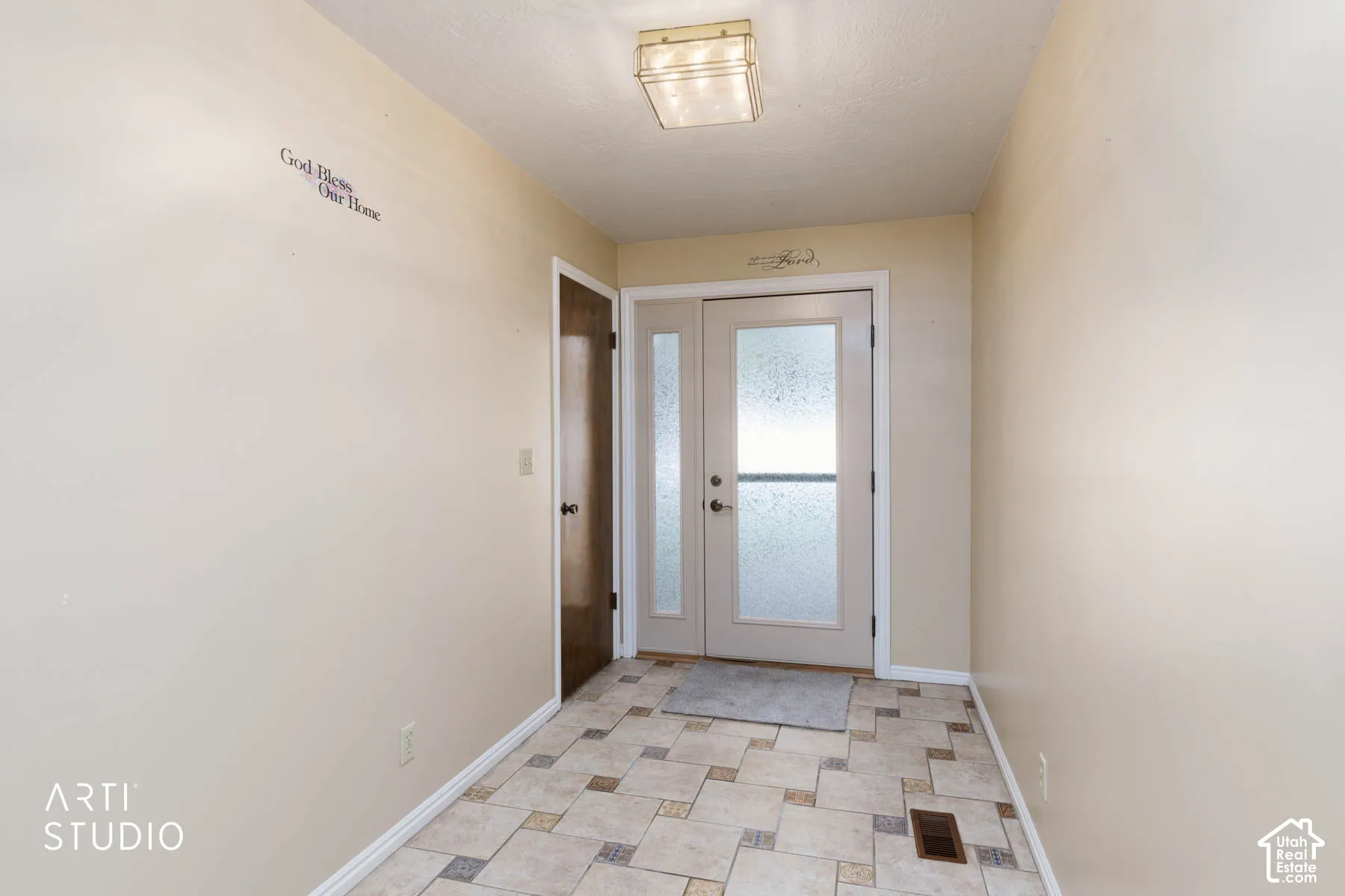 Dual entry doors with privacy glass, recessed ceiling light fixture, tile flooring, and a single paneled interior door