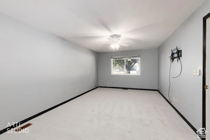 Room with light grey painted walls and light-colored carpet flooring