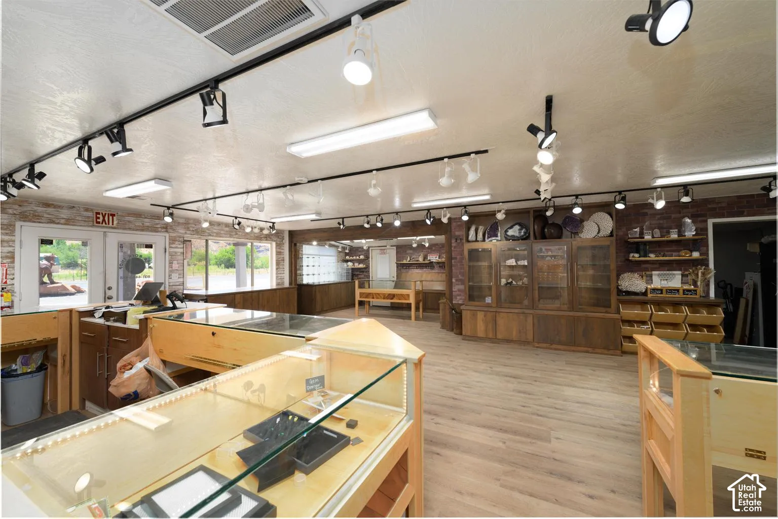 Expansive commercial space featuring track lighting, recessed lighting, and wood-finish flooring