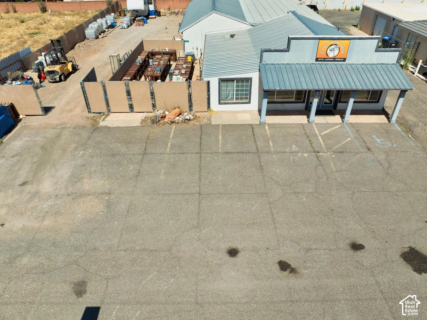 Building featuring a metal roof, prominent storefront, and covered entry