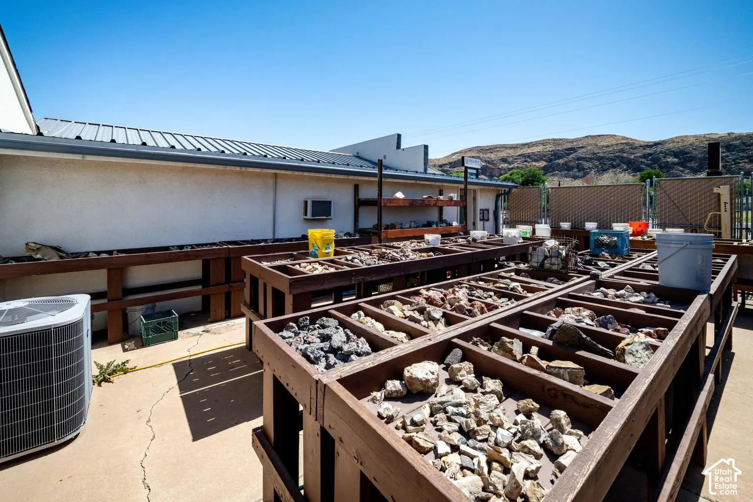 Outdoor display area featuring multiple elevated wooden bins