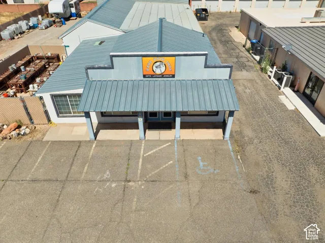 Commercial building featuring a prominent entrance canopy and a corrugated metal roof