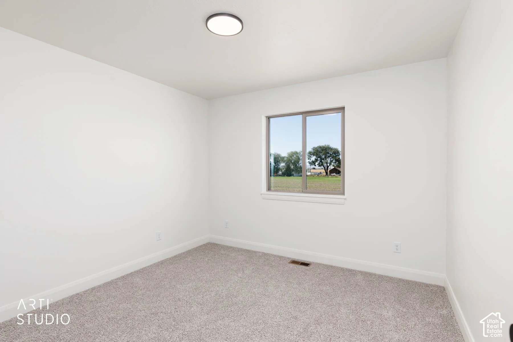 Upstairs bedroom 2 with neutral toned carpeting, white walls, flush mount ceiling light, and a horizontal window