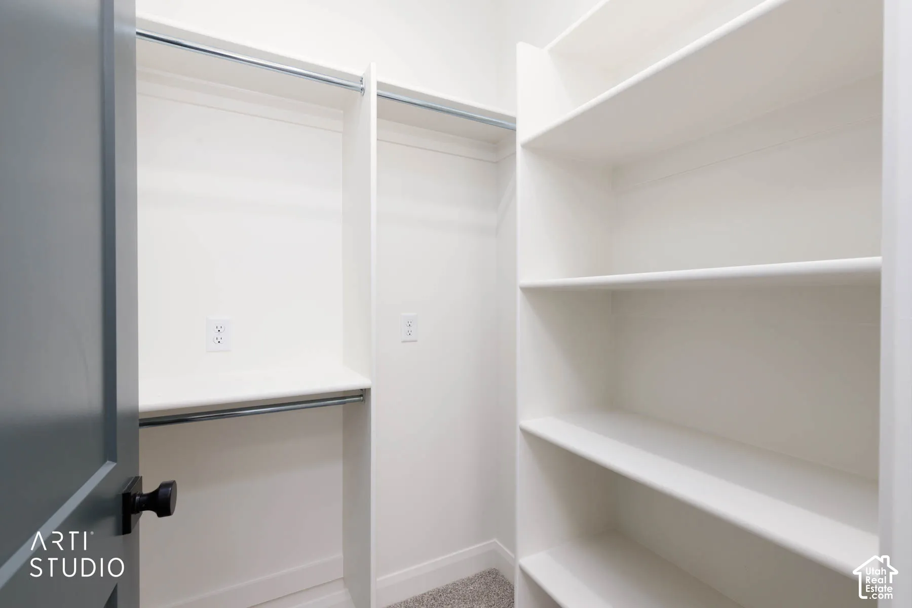 Built-in shelving, two clothing rods, and wall outlets