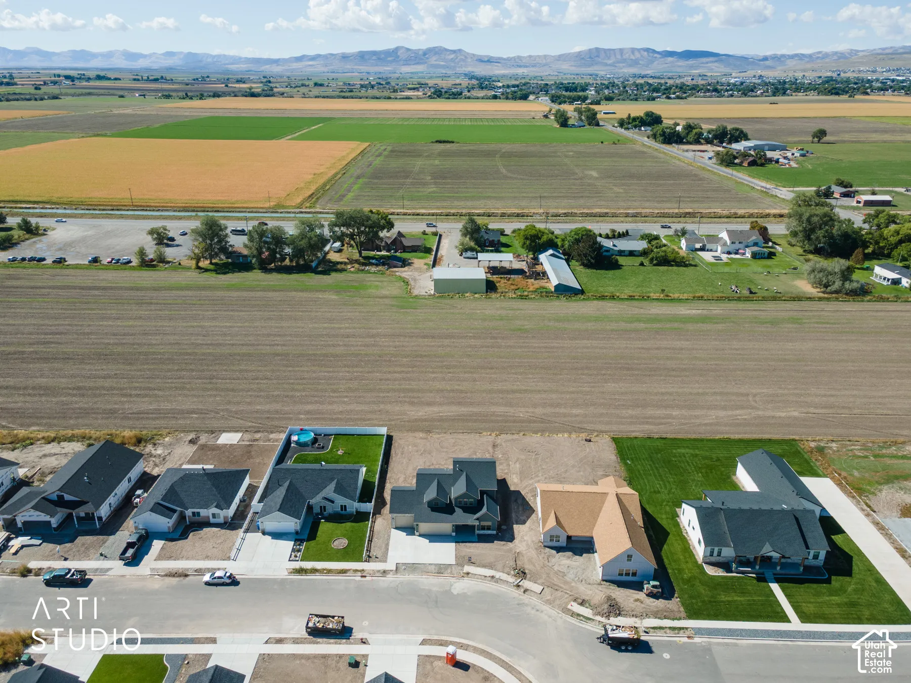 Aerial perspective showcasing a developing residential street with new construction and established homes