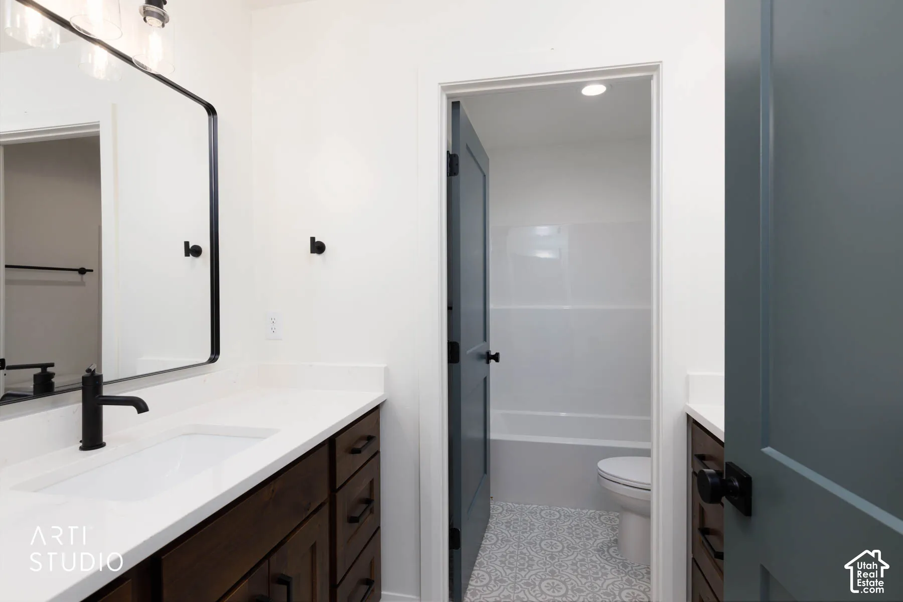Upstairs bathroom with two vanities and separate toilet/tub area